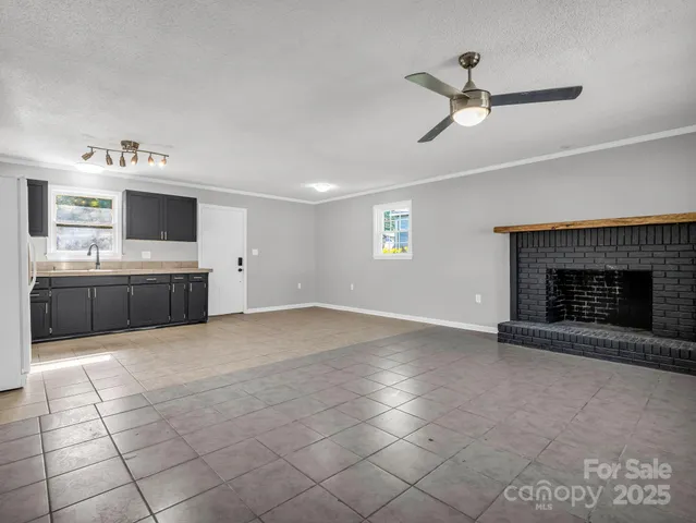a large kitchen with a stove and a fireplace