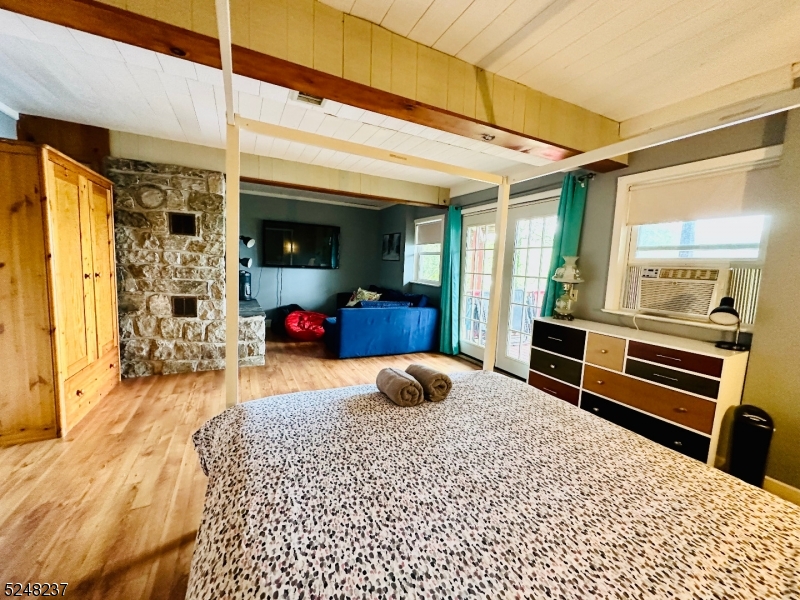 639 Canistear Road Vernon, NJ 07422 - Photo 15 of 23 a bedroom with a bed and wooden floor