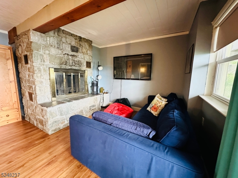 639 Canistear Road Vernon, NJ 07422 - Photo 16 of 23 a living room with furniture fireplace and flat screen tv