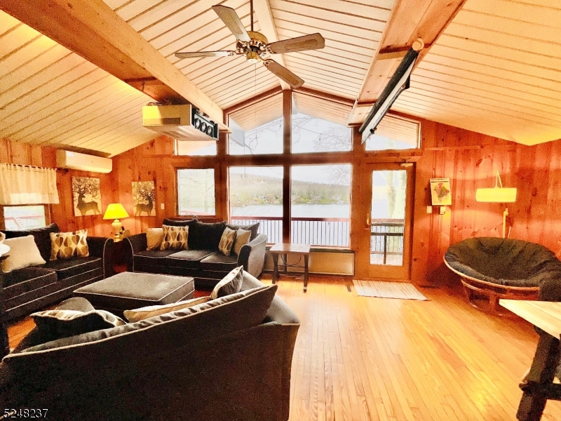 639 Canistear Road Vernon, NJ 07422 - Photo 2 of 23 a living room with furniture and a floor to ceiling window