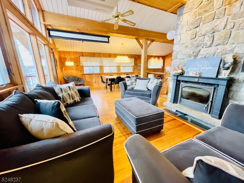 639 Canistear Road Vernon, NJ 07422 - Photo 3 of 23 a living room with furniture a fireplace and next to a window