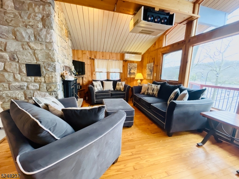 639 Canistear Road Vernon, NJ 07422 - Photo 4 of 23 a living room with furniture and a flat screen tv