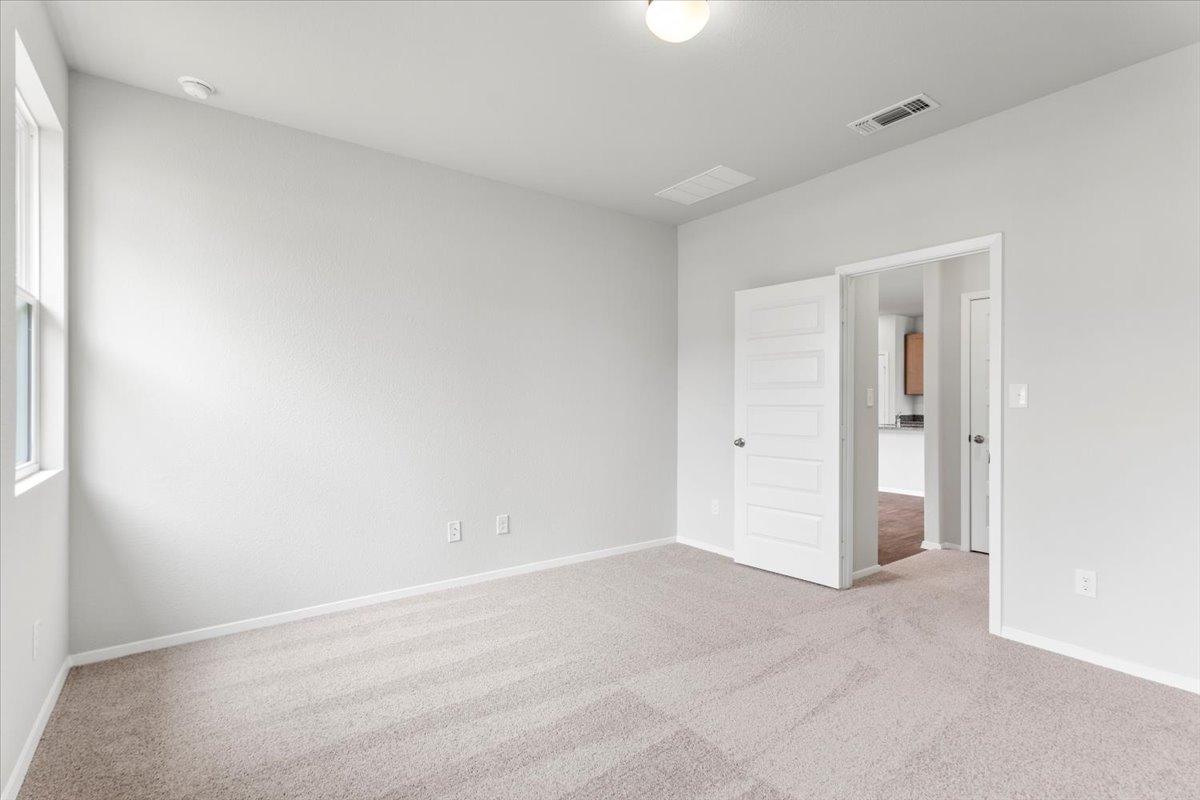 2603 Totley Road Manor, TX 78653 - Photo 17 of 37 Spare room featuring carpet floors and baseboards