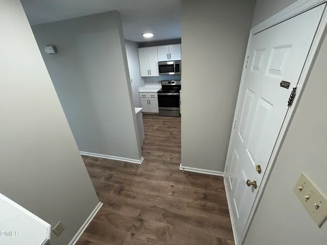 a view of a kitchen from a hallway