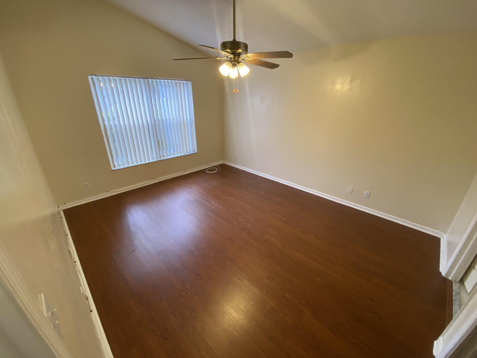 1051 Aviary Road Wellington, FL 33414 - Photo 5 of 10 an empty room with windows and fan