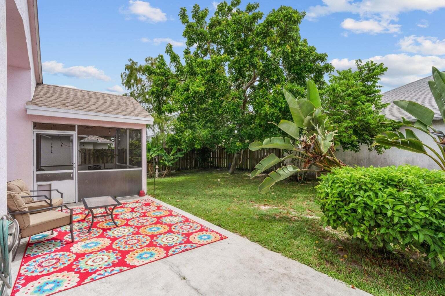 1051 Aviary Road Wellington, FL 33414 - Photo 9 of 10 a backyard of a house with table and chairs