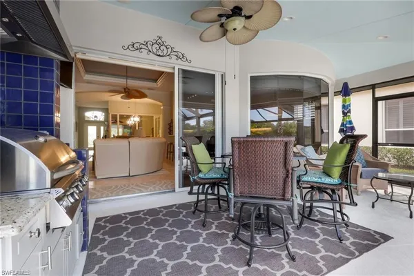 a view of a dining room with furniture a chandelier and wooden floor