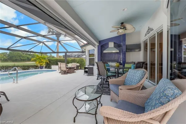 a view of a patio with a table and chairs under an umbrella