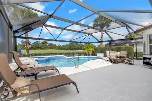 a view of swimming pool with outdoor seating
