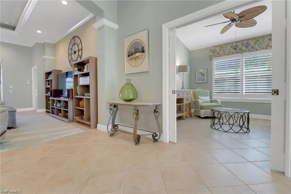 a view of a livingroom with workspace and a window