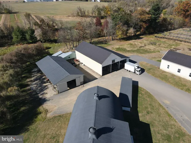 an aerial view of multiple houses with yard