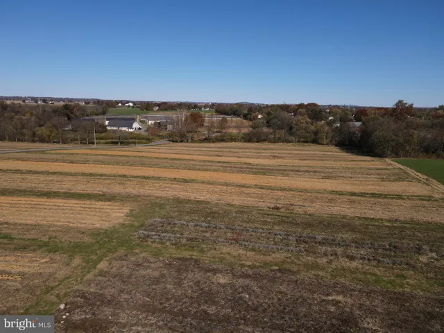 an aerial view of a houses with a yard