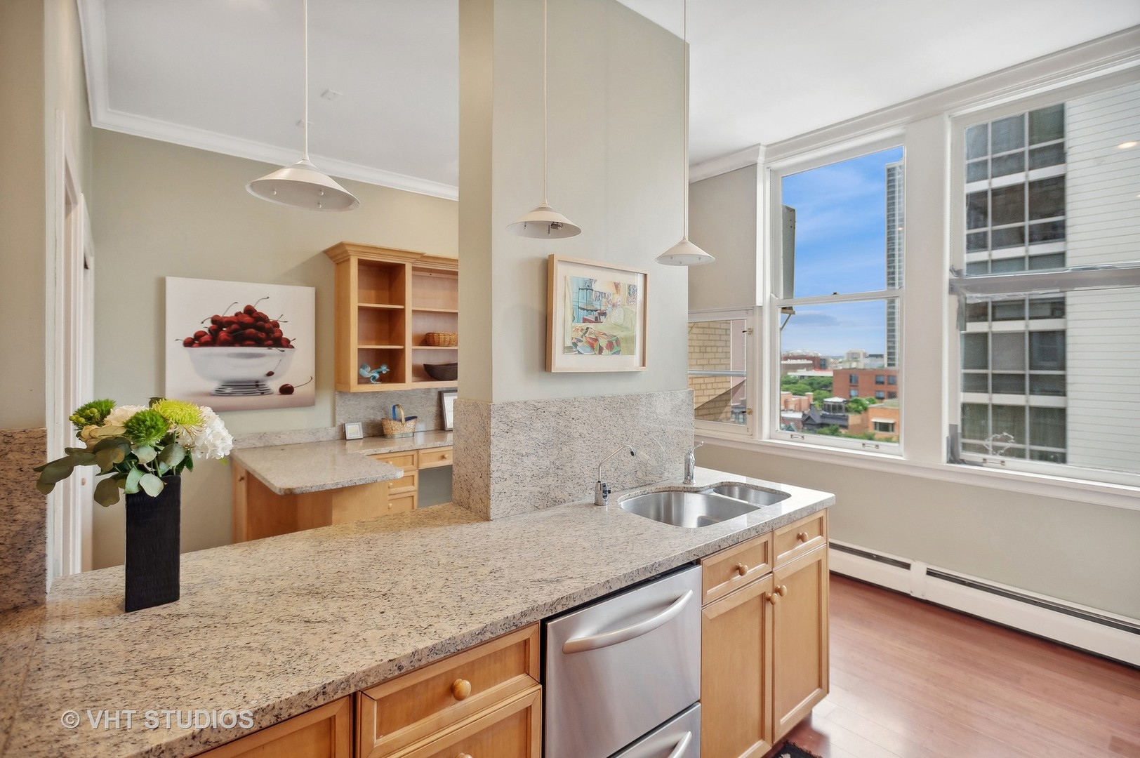 1550 North State Parkway, Unit 501 Chicago, IL 60610 - Photo 12 of 20 a kitchen with stainless steel appliances granite countertop sink and wooden cabinets