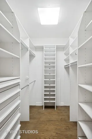 a view of walk in closet with empty racks