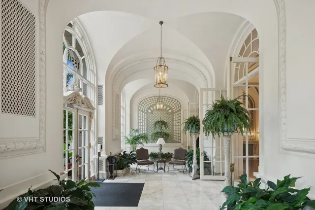 a view of a hall way with furniture
