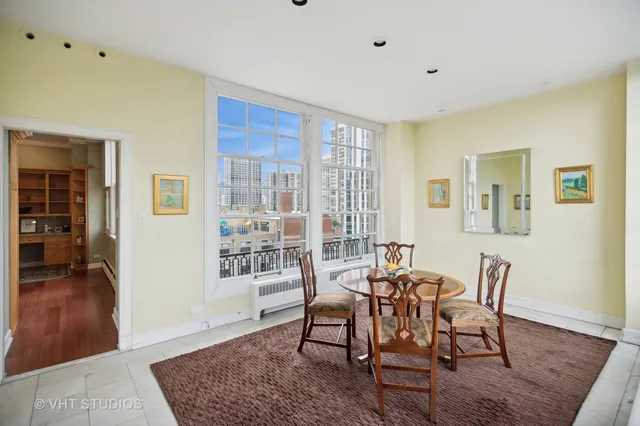a dining room with wooden floor and a rug