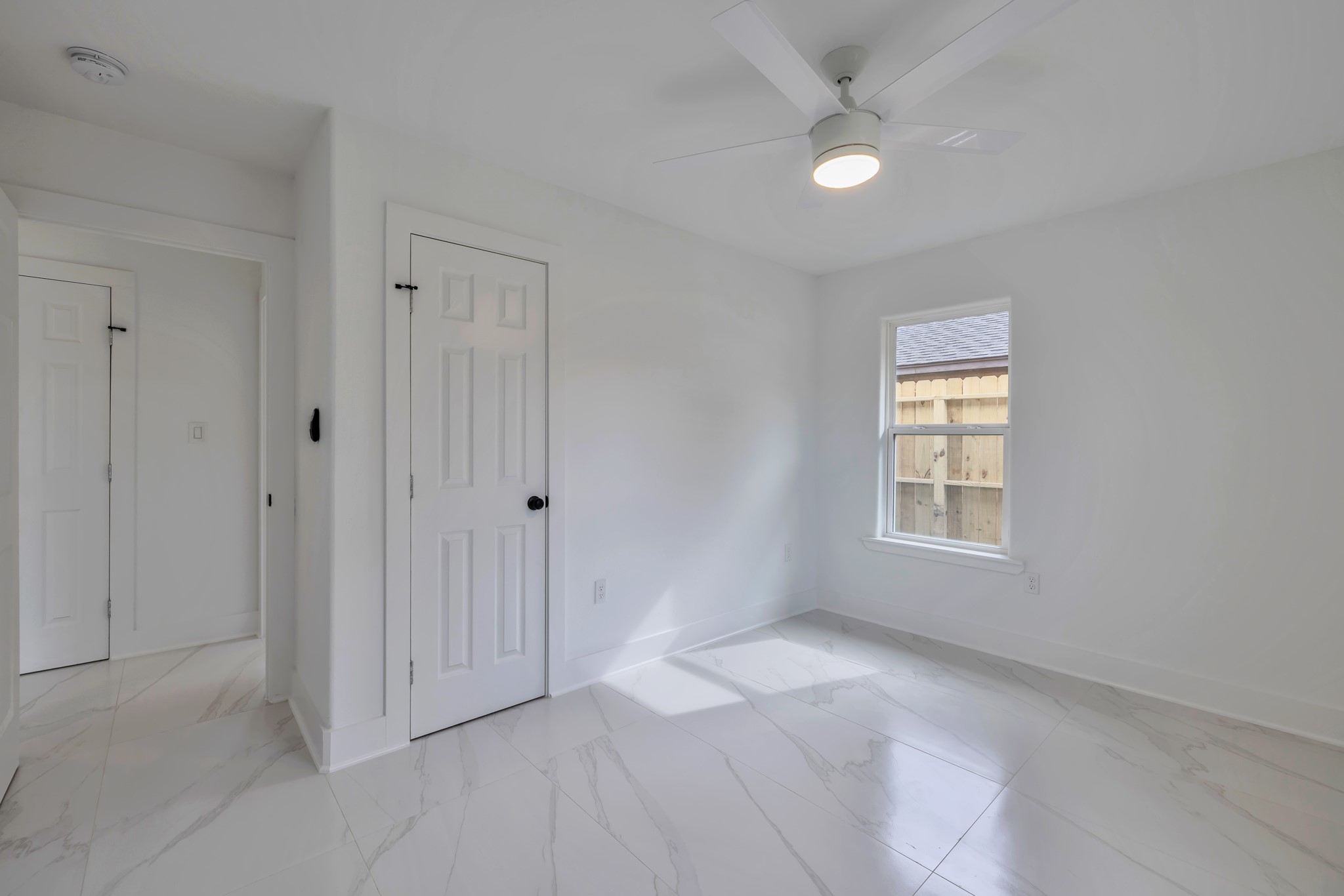 8709 Tarbell Road Houston, TX 77034 - Photo 15 of 25 a view of an empty room with a window