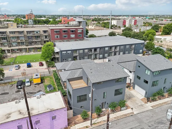 an aerial view of a house with a garden and outdoor seating