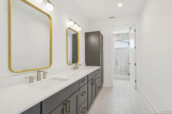 a bathroom with a double vanity sink mirror and double