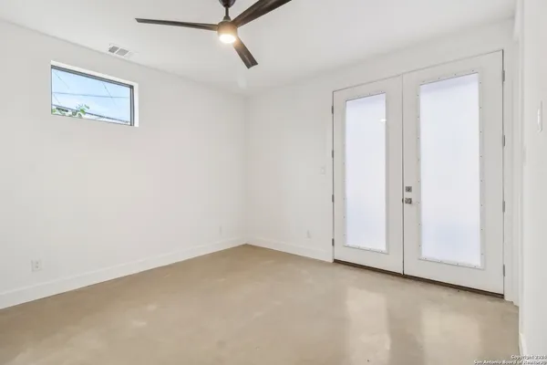 an empty room with closet and windows