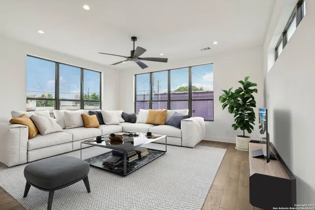 a living room with furniture potted plant and a window
