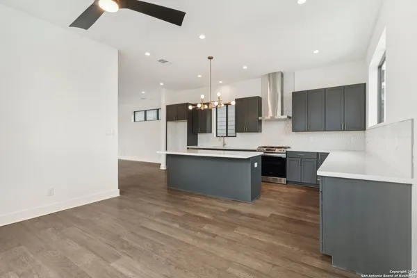 a kitchen with a sink appliances and cabinets
