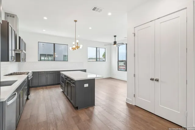 a kitchen with a sink appliances and cabinets