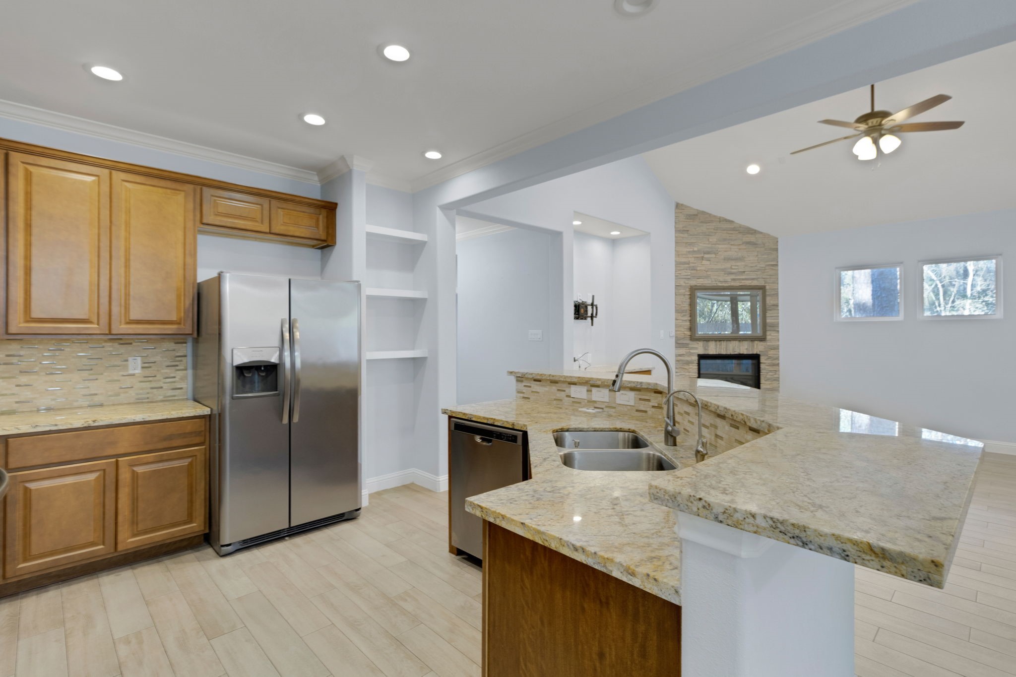 30 Beachwood Way Coldspring, TX 77331 - Photo 11 of 47 a kitchen with stainless steel appliances granite countertop a sink a stove and a refrigerator