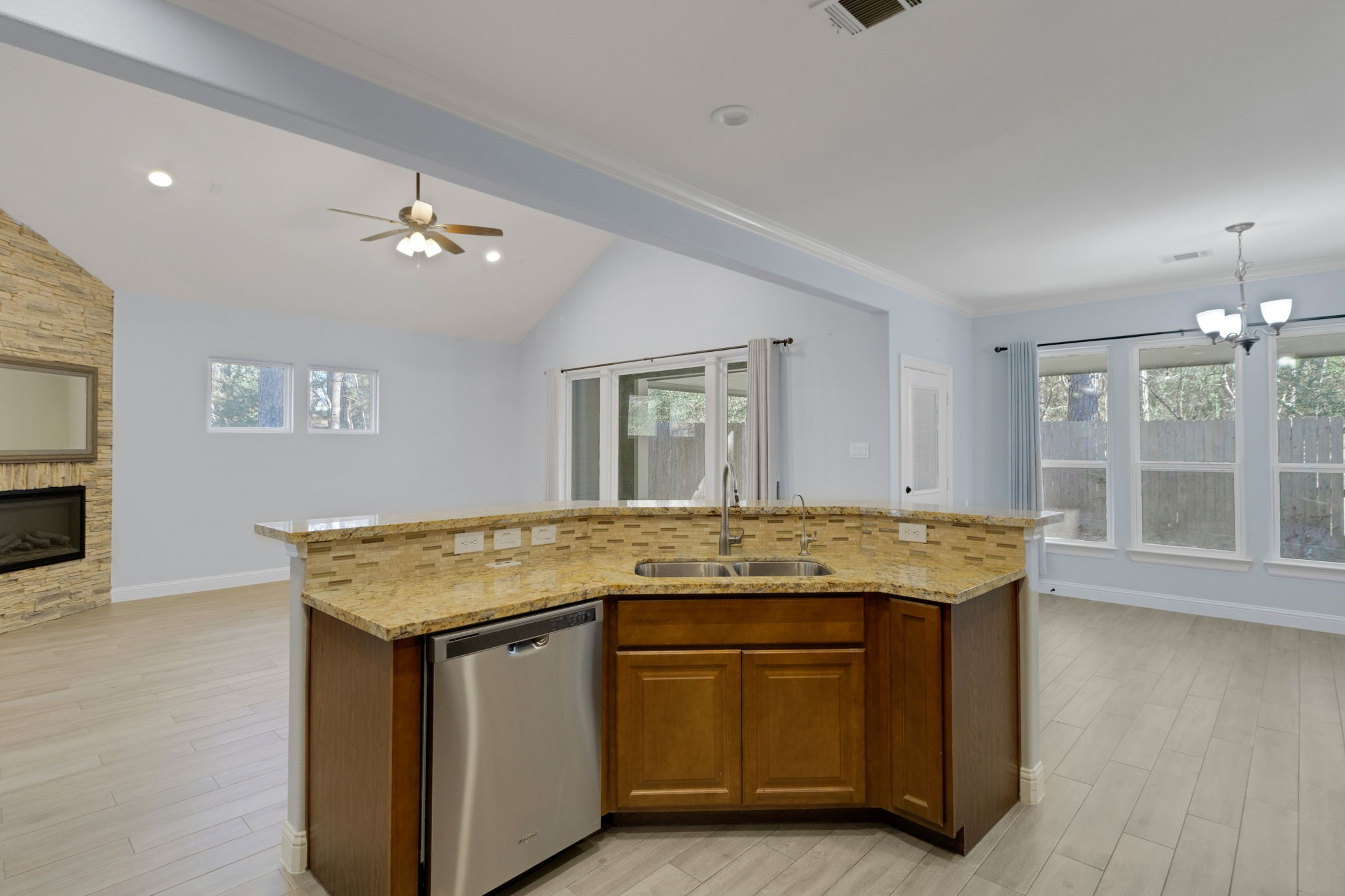 30 Beachwood Way Coldspring, TX 77331 - Photo 12 of 47 a view of a granite countertop kitchen island with stainless steel appliances granite countertop a stove and a wooden floors