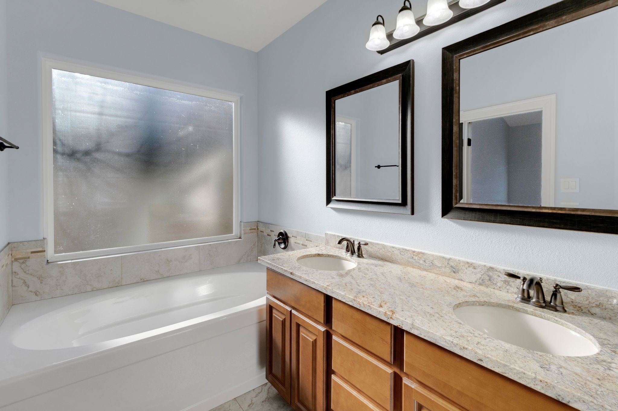 30 Beachwood Way Coldspring, TX 77331 - Photo 22 of 47 a bathroom with a granite countertop sink mirror and a bathtub