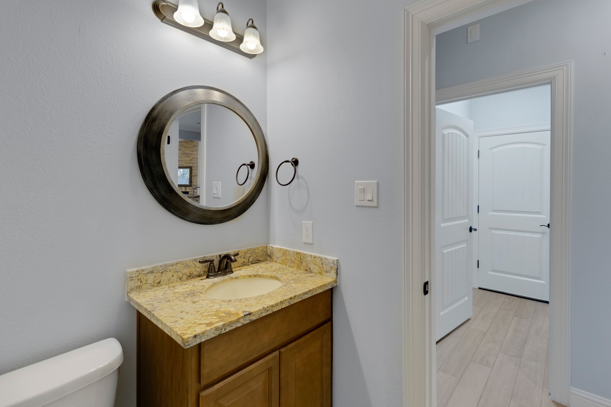 30 Beachwood Way Coldspring, TX 77331 - Photo 24 of 47 a bathroom with a granite countertop sink and a mirror