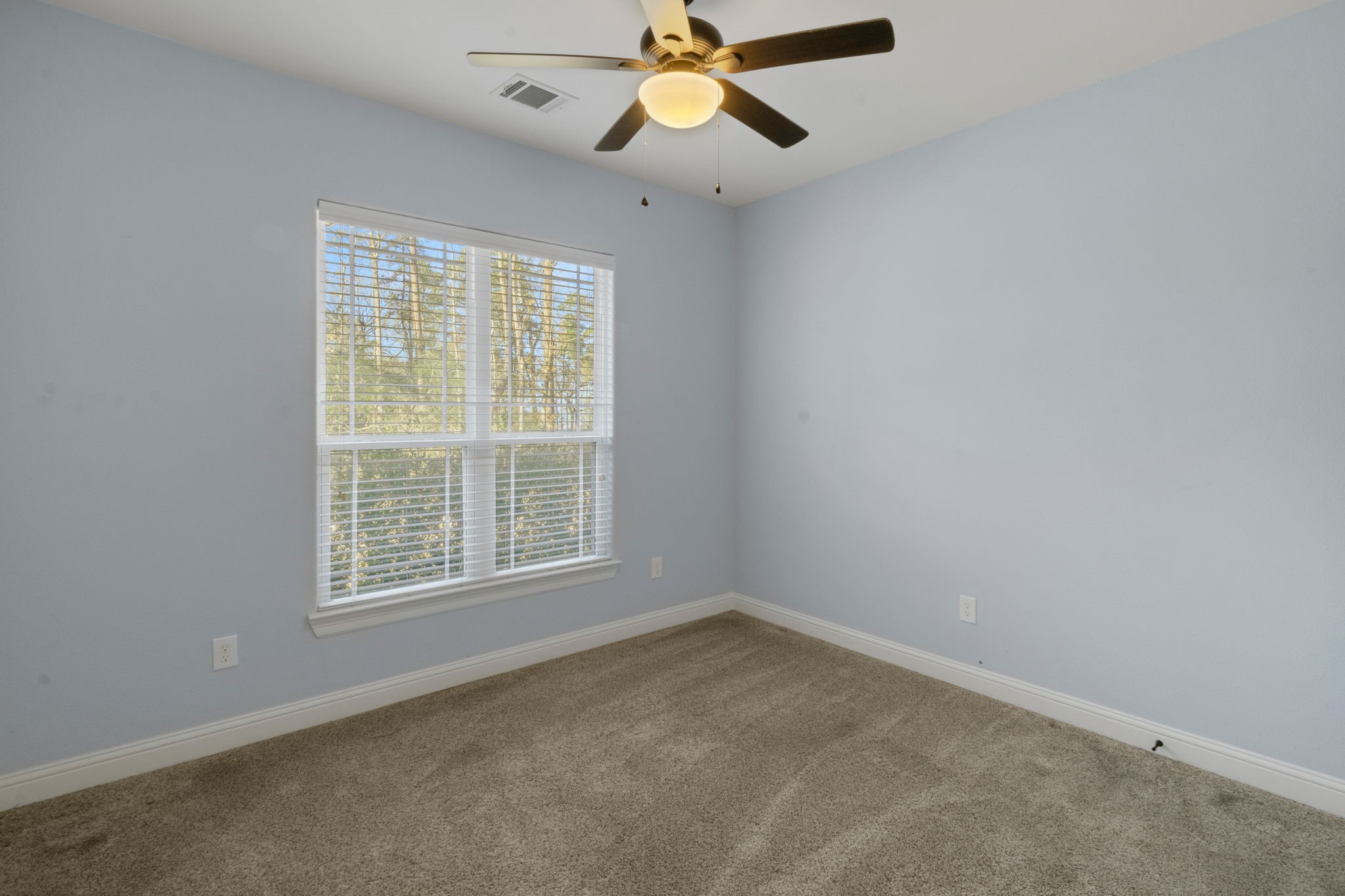 30 Beachwood Way Coldspring, TX 77331 - Photo 28 of 47 an empty room with a window and a fan
