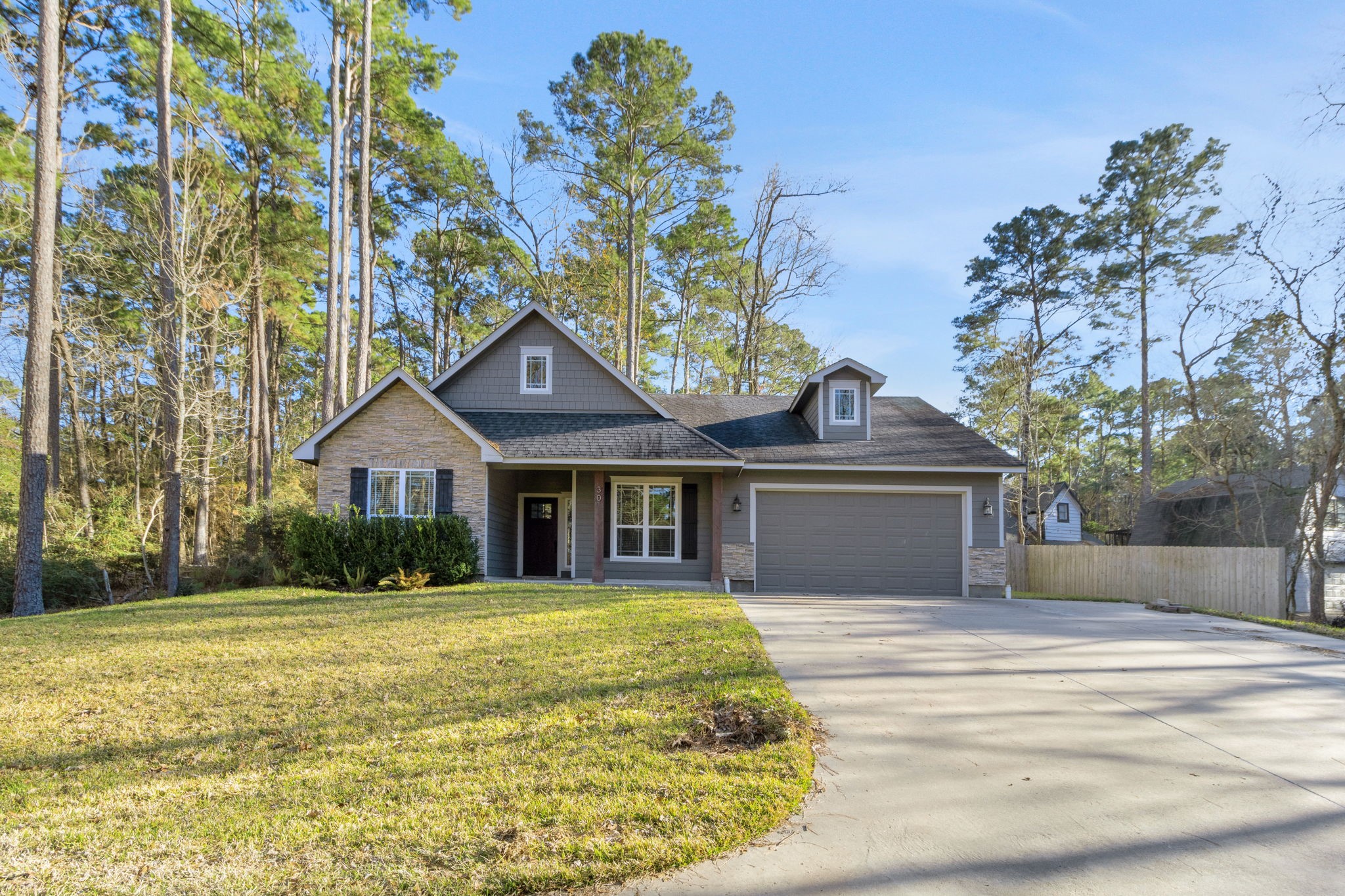 30 Beachwood Way Coldspring, TX 77331 - Photo 36 of 47 a front view of a house with a yard and trees