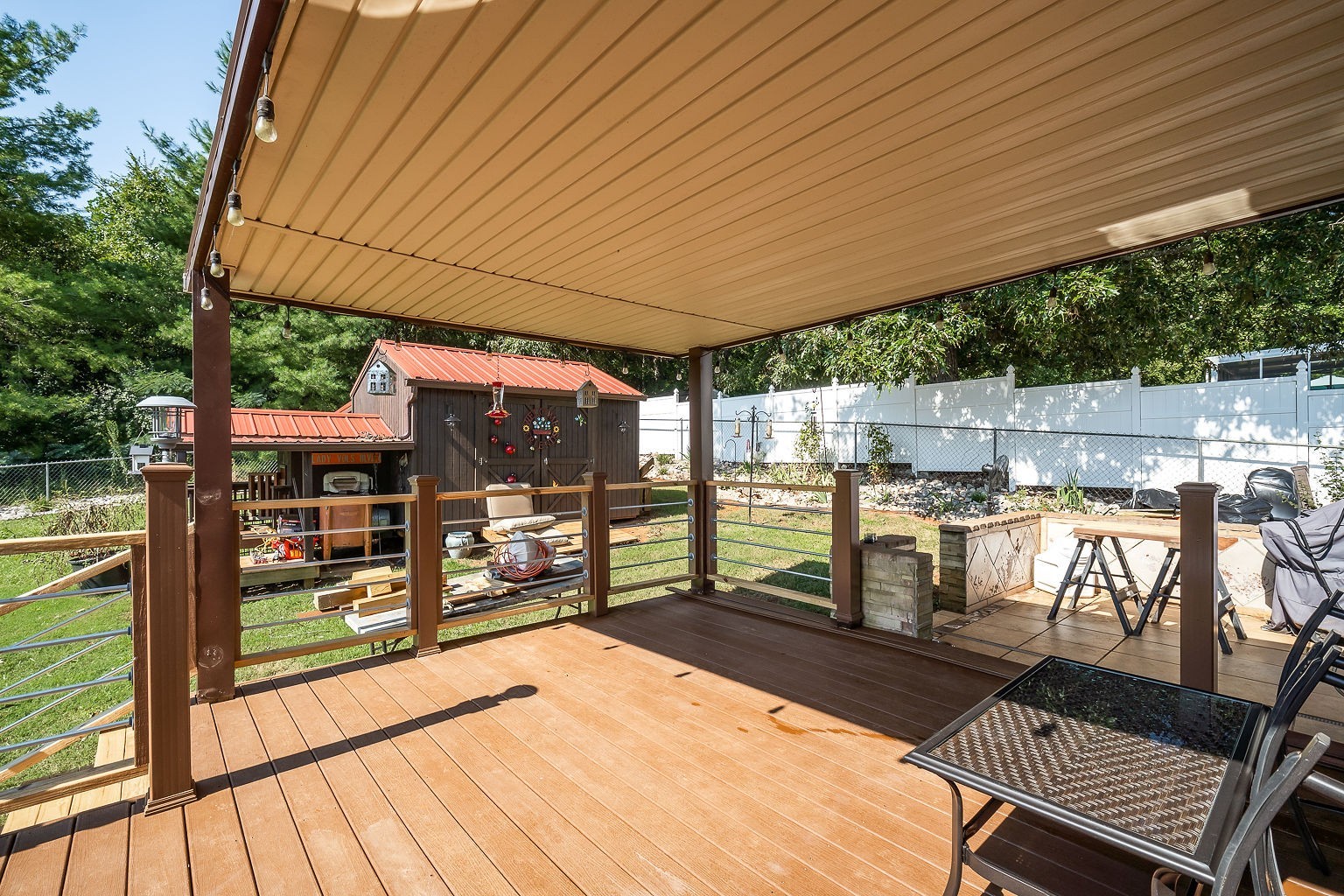 128 Simons Boulevard Morrison, TN 37357 - Photo 27 of 65 a view of a patio with table and chairs potted plants with wooden floor and fence