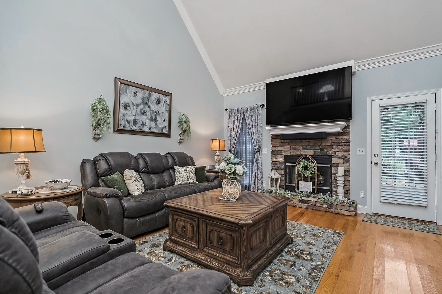 128 Simons Boulevard Morrison, TN 37357 - Photo 32 of 65 a living room with furniture a flat screen tv and a fireplace