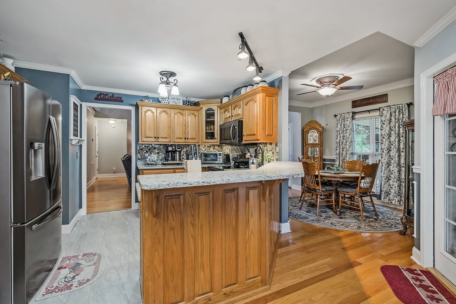 128 Simons Boulevard Morrison, TN 37357 - Photo 42 of 65 a kitchen with stainless steel appliances kitchen island granite countertop a refrigerator a stove a sink and a dining table with wooden floor