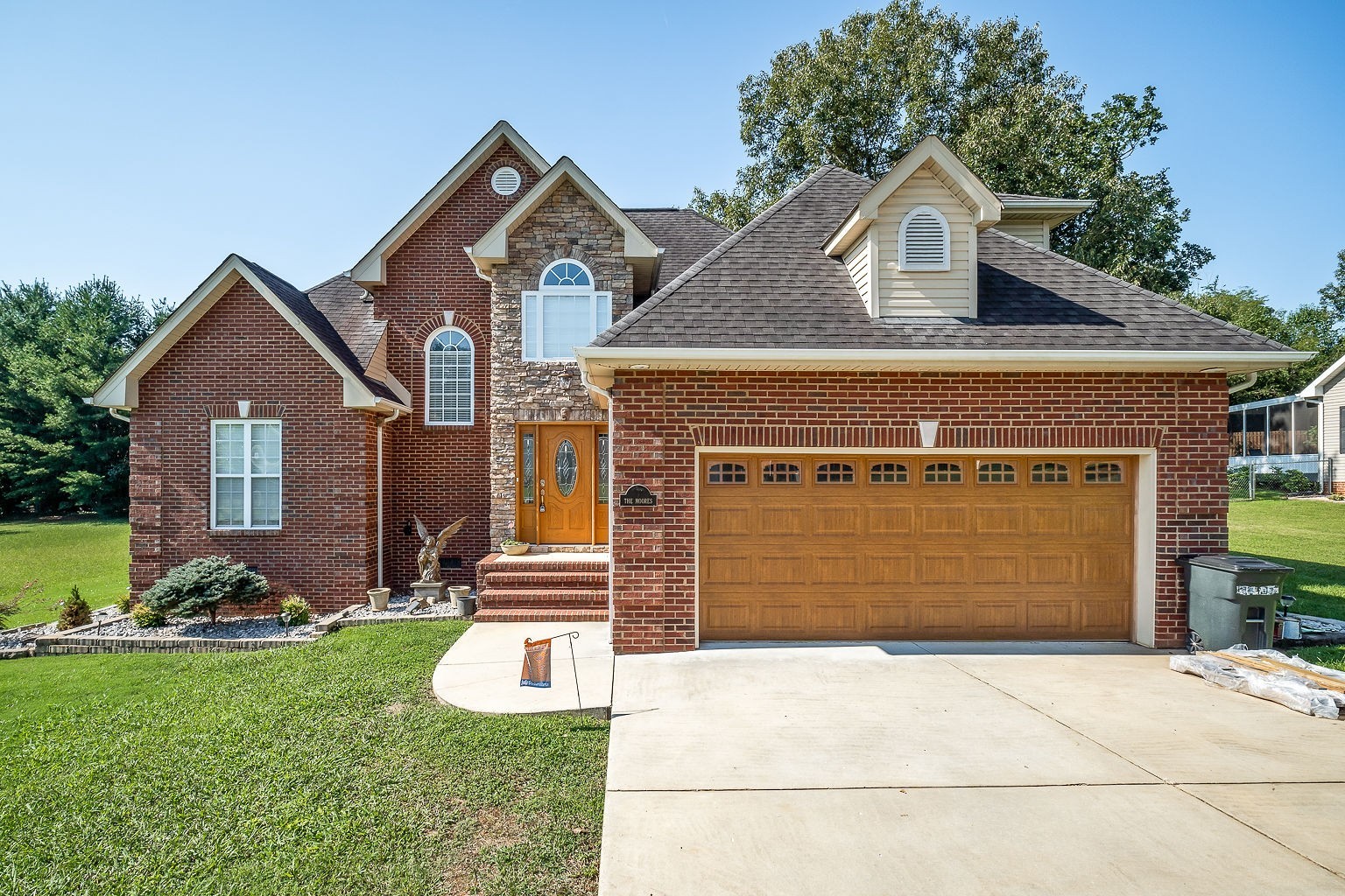 128 Simons Boulevard Morrison, TN 37357 - Photo 6 of 65 a front view of a house with a yard and garage