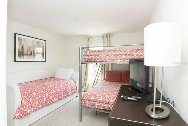 a bedroom with a bed and a dresser with the shoe rack