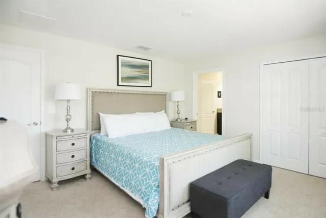 a bedroom with a bed and a night stand