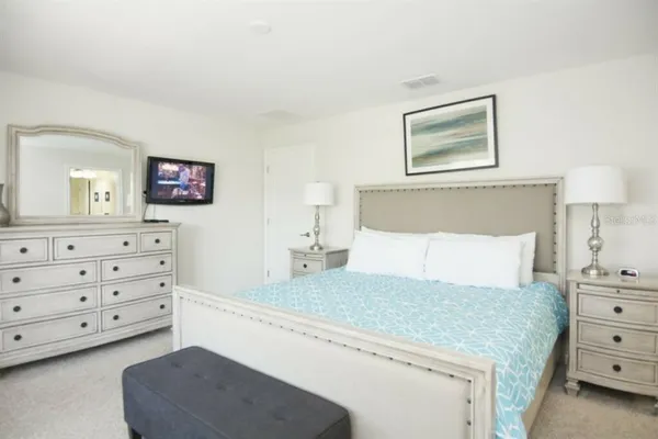 a bedroom with a bed and a dresser