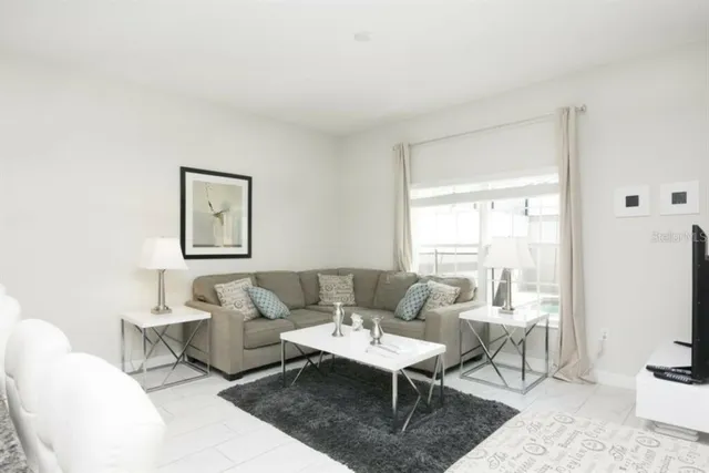 a living room with furniture a rug and a window