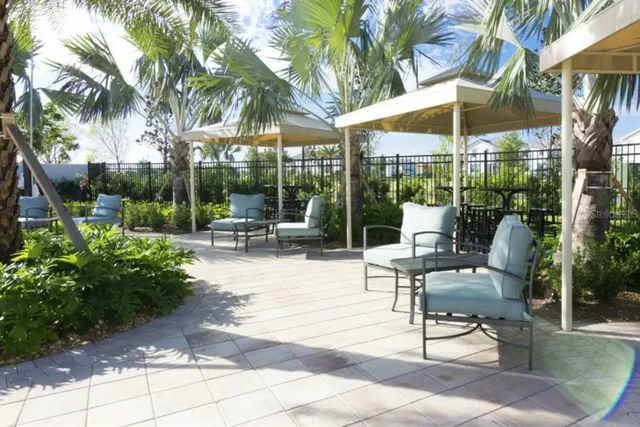 a view of a lake with a table and chairs