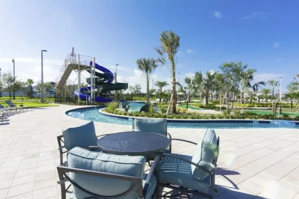 an outdoor space with swimming pool and outdoor seating