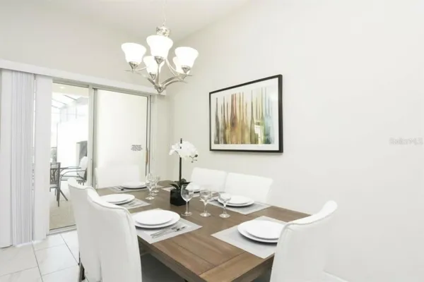 a view of a dining room with furniture and chandelier