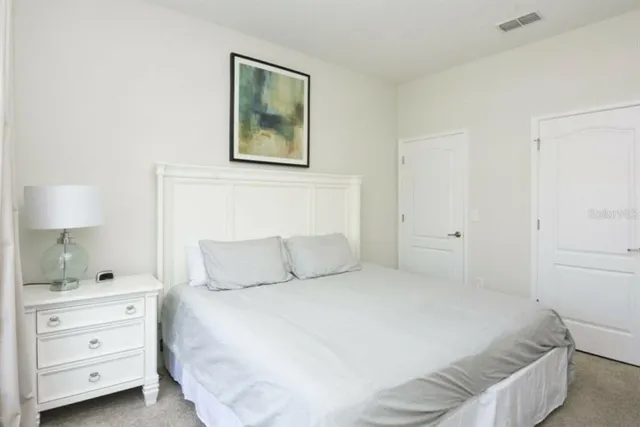 a bedroom with a bed and a night stand