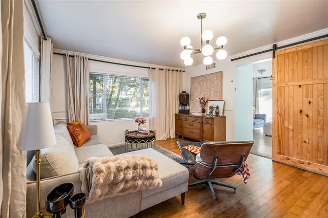 a spacious bedroom with a bed and glass door
