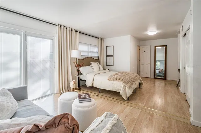 a spacious bedroom with a bed and a table