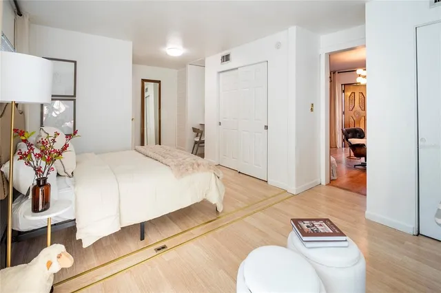 a view of a room that has a closet and mirror in it