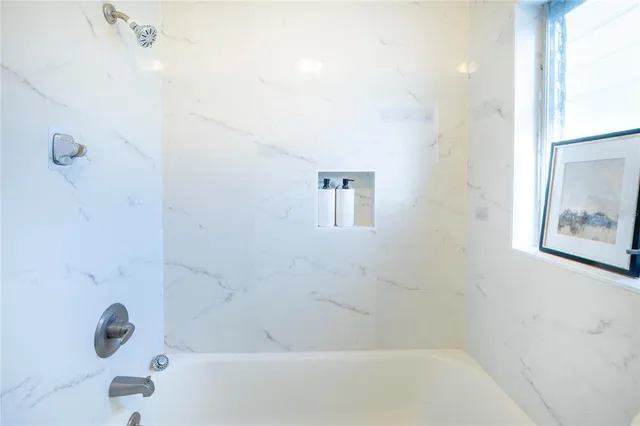 a bedroom with a bed and a potted plant