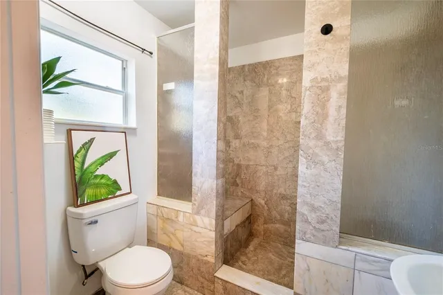 a dining room with furniture and a floor to ceiling window